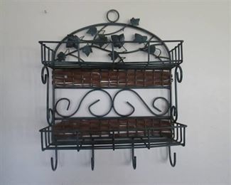 Green metal wall shelf with ivy decorations