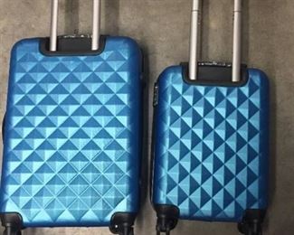 Unused 2 piece  Blue luggage small one will fit inside of large one swivel wheels