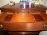 Lift-top box in center of top drawer.
