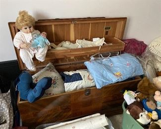 Cedar chest, blankets, dolls