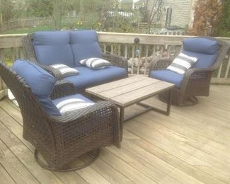 Outdoor patio set...Rattan with blue cushions.  One year old. Loveseat measures 55w x 33 d x 38.5 t. 2 swivel chairs measure 32" wide and table measures 40" l x 23" w x 18" t.  Set is $395