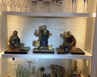 Smalls for sale on lower shelf.  The feature items are the three Shiwan mud figures of working class people.  The top shelf's glassware is $5 a stem, sold in sets only. Not sown, a Tiffany of New York sangria pitcher with orignal stirrer also in crystal.