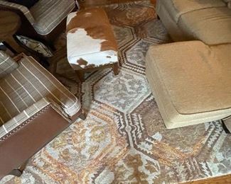 Area rug and cowhide ottoman 