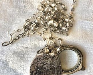 $25 Silver tone magnifying glass (opens but looks like pendant closed)  on  beaded chain 46" long , pendant 2" long 
