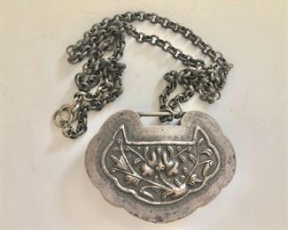 $60 Asian motif silver tone pendant on chain.  22"L and pendant: 2"L