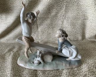 #6 Lladro “Seesaw Friends” 4867, a boy and a girl playing seesaw with a small dog—$150