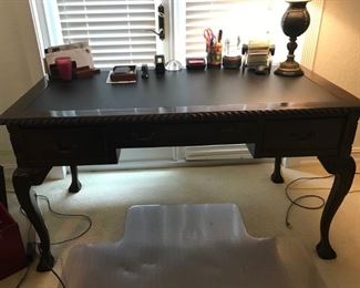 Mahogany Desk with 3 drawers, carved and leather top. 54"Wx30"Dx35"H