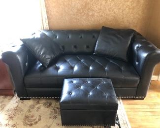 Black vinyl sofa and ottoman