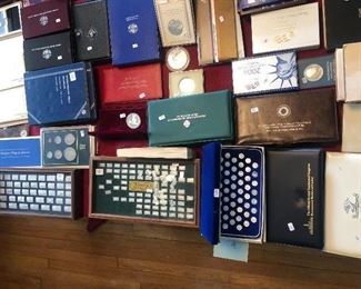 Table with coin collection, proof sets & Sterling collectibles by Franklin mint