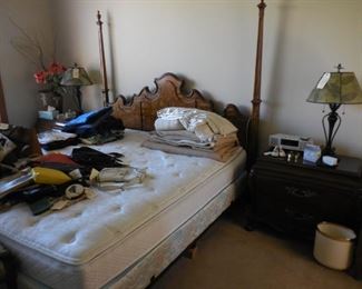 King size Sleep Number bed with poster headboard; bedside table; ladies handbags