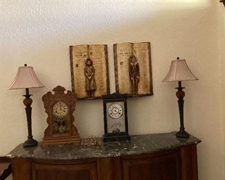 PAIR OF DICKENS CHARACTERS ON PLASTER BOOK BACKING. ANTIQUE OAK GINGERBREAD CLOCK, EASTLAKE REVERSE PAINTED MANTLE CLOCK. PAIR OF CANDLESTICK STYLE TABLE LAMPS.