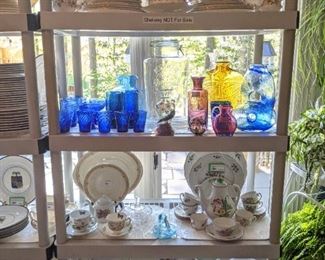 Shelving of kitchen goodies, with china sets, Blenko Glass, etc.