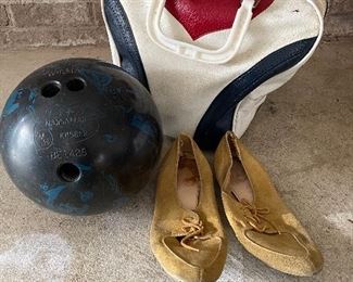 Vintage bowling case with ball and shoes.