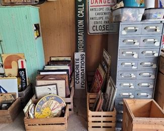 Grey cabinet full of crystals, rocks, fossils and more, and more signs