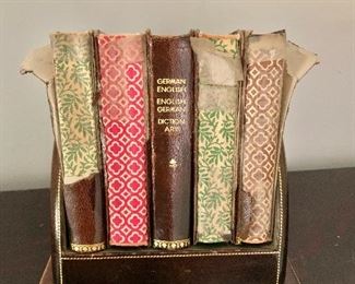 $34 - Collection of vintage books in vintage, leather book holder