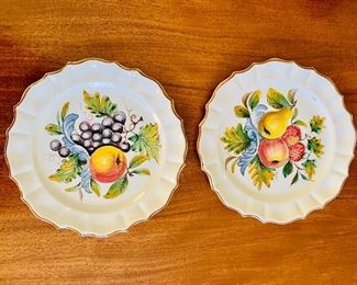 $30 - Pair of decorative fruit motif ceramic gold tone rimmed plates; 9 1/2" diameter