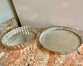 $15 each - Tart/Quiche pans with removable bottom; Pan on left 1 3/4"H x 10 1/4" diameter. Pan on right 1"H x 10" diameter 