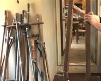 Two pairs of stilts, lots of outdoor tools, shovels, rakes