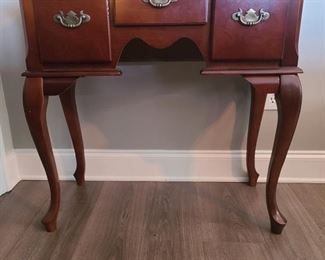 Cherry finish entry table with cabriole style legs and has three drawers for storage. Table measures 32" x 16" x 31". https://ctbids.com/#!/individualEstateSales/316/9887
