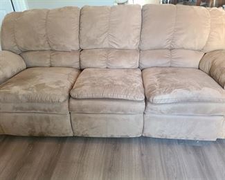 Tan reclining couch is made of microsuede. Both ends recline and the mechanisms work perfectly. The only problem you will have with this couch is not falling asleep once sitting down. Measures 84" x 38" x 35". https://ctbids.com/#!/individualEstateSales/316/9887