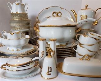 Vintage Hutschenreuther 81 pc china set in Selb pattern. Dishes are a gorgeous white with gilded gold trim. Set includes tea cups, saucers, platters, plates, soup terrain, tea pot, dessert plates, bowls, salt and pepper set, bell and sugar and creamer set. https://ctbids.com/#!/individualEstateSales/316/9887