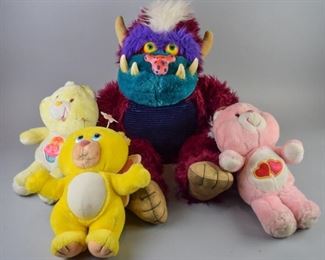 14	My Pet Monster and Care Bears	A grouping of four plush dolls from the 1980's, including a My Pet Monster, and three Care Bears. All are in good condition and have seen heavy use and wear.

