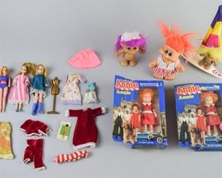 20	Grouping of Collectible Dolls	A grouping of collectible dolls, including: Three Troll dolls with clothing and surfboard Two carted Annie dolls, one with locket Three Dawn dolls (circa 1970's) with mannequin and clothing All good condition, box has some wear.
