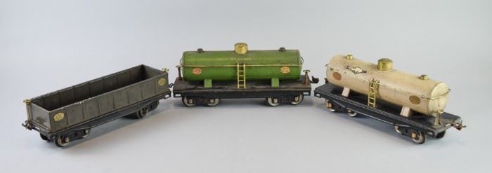 23	Trio of Lionel Train Cars	A group of 3 Lionel train cars, including Lionel Lines No. 212 gondola car marked "capacity 80,000 lbs.", still with original tag. Two No. 215 oil cars, one green (tagged) and one silver. Good condition.
