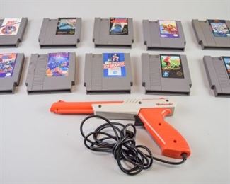 38	NES Games with NES Zapper and Mega Man	A group of 10 Nintendo Entertainment System Game Paks and an orange NES Zapper, a light gun used for games such as Duck Hunt. Game titles include Golf, Ice Hockey, Tetris, Duck Hunt, Mega Man 3, Bases Loaded II, Mega Man, Jaws, Mickey Mousecapade, and Tiger Heli. All in very good condition with some use and wear.
