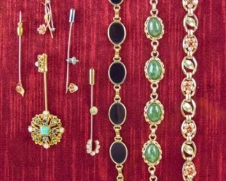 102	Grouping of Bracelets and Pins	Lot includes gold tone bracelet with green stones; gold tone bracelet with black stones; gold tone bracelet with rose gold tone roses with matching pin; four gold tone stick pins with faux stones
