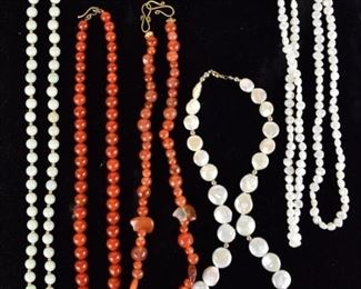 104	Grouping of Beaded Necklaces	Lot includes 14k jade/jadeite beaded necklace with 14k gold clasp and spacer beads 26"; carnelian beaded necklace 18"; orange agate beaded necklace with 4 bear shaped beads 18"; freshwater coin pearl necklace with 575 gold clasp; 19"; baroque freshwater pearl necklace 32"
