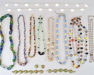 105	Grouping of Glass and Stone Bead Necklaces	Colorful Venetian Murano glass millefiori beaded necklace with graduated bead size; opalescent white glass painted Murano glass bead necklace; painted blue and gold glass bead necklace; shades of green, blue and white chunky glass beaded necklace; multi strand colorful glass beads/silver tone beads necklace; turquoise colored glass beads with black accents; pale amber colored and green glass beads with gold tone accent beads, green glass with gold paint beads (broken necklace.)
