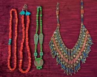 111	Grouping of Egyptian Revival Beaded Necklaces	Egyptian revival unsigned bib necklace; closure needs repair; green stone necklace with carved pharaoh beads; 15 inches; one red beaded necklace with three green accent beads, stretch string; one red beaded necklace with turquoise bear accent beads, brass clasp, 18 inches
