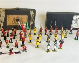 123	Grouping of Lead Toy Soldiers	Various makers including Britains and Queen Victoria's Ent. 12 Piece lead figurines marching band by Queen Victoria's Ent. Canada. In original box. Magico 19 piece lead soldiers in box 19 Britains and Magico lead soldiers including marching band pieces.
