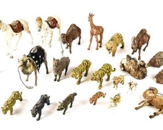 124	Grouping of Composition & Other Animal Figurines	24 animal figurines including pair of tigers, giraffe, 2 camels, zebra, llama, sitting camel, panther, wolf, 3 composition & wood camels, 2 ceramic lions, porcelain dog, porcelain leopard, papier mache dog, 3 papier mache horses. Losses and wear throughout. Largest horse 7 1/4"H
