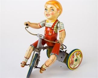143	Unique Art Mfg. Co Kiddy Tin Litho Wind-Up Cyclist	Tin litho wind-up toy Kiddy Cyclist by Unique Art Mfg. Co., Inc. 8 1/2". Some paint loss.
