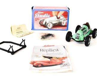 148	Schuco Studio Car Mercedes Grand Prix 1936	Friction/wind-up car, with winder and set of miniature Schuco tools, stand, original box and paperwork. Some wear to box. Car 5 1/2"L x 2 1/4"H. Made in West Germany
