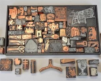 179	Grouping of Vintage Printing Blocks	Lot includes printer's letterpress blocks of various sizes. Images include scissors, sewing machine, telephone, candle, clover, dice, golf clubs; largest measures 5" x 3 1/2"; metal and wood blocks; good condition
