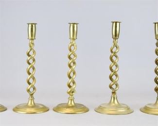 185	Grouping English Brass Barley Twist Candlesticks	2 pairs and one single candlestick, all with barley twist stems. One stamped England. Tallest pair 12"H

