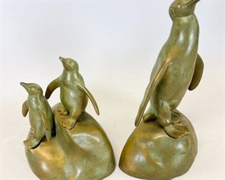 190	Pair of McClelland Barclay Bronze Penguin Bookends	A pair of bronze penguin bookends created by McClelland Barclay (1891-1943). Signature on the back of the base on each piece. The first bookend features a lone penguin with wings extended. Scratch below right flipper. The other features two penguin checks perched on a rock in a similar fashion to the adult penguin bookend. Penguin bookend 5"L x 3" W x 8.5" H. Penguin chicks bookend 5" L x 3" W x 6" H
