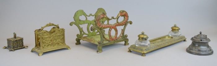 203	Grouping of Desk Items	Hand painted figural cast iron book rack, 9 3/4"L x 7"W x 6 1/2"; inkwell (missing glass insert), 4"H; brass letter rack, 6"L x 5 1/4"H; brass double inkwell with two brass & glass bottles, 13 1/2"L; squirrel inkwell 3"H. Bottom of one glass bottle chipped, roughness to glass insert on squirrel inkwell
