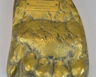 206	Large Solid Brass Casting of Grizzly Bear Paw	Solid brass with plaque reading "Alaskan Brown/Grizzly Bear (Ursus Arctos)"; engraving on back reads "Hand Crafted in England of Solid Brass, Copyrighted Barry Johnson 1983." measures 11"x7 1/2"
