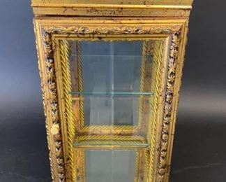 212	Table Top Gilt Wood Vitrine	Gilt wood table top vitrine with marble top, rope decorated interior and two glass shelves. 9 1/2"W x 9 1/2"D x 19 1/4"H. Losses to gilt along top
