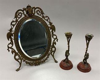216	Grouping of Decorative Metal Items	Pair of bronze frog candlesticks on marble bases, each 8 1/2"H; gilt metal dresser or vanity mirror, stamped B multiple times on verso, 14"H x 10 3/4"W. Chips to marble bases of candlesticks
