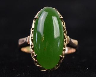 363	Gold Ring with Jade	An 18 karat gold ring with a green stone, most likely jade. Measures 1" long. Good condition, weighs in at 4.27 grams
