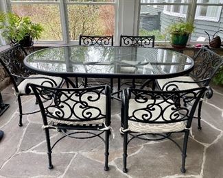 Wrought Iron glass top oval table w/ 6 wrought iron chairs w/ cushions