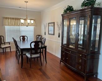 LIKE NEW...Pulaski formal dining room set...Table and chair upholstery have been protected since purchased...Seats 8 with leaf...Matching china cabinet...Custom table pads
