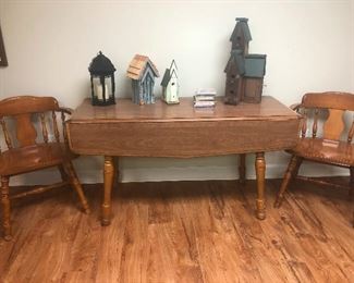 drop leaf dining table topped with array of birdhouses you need this in your life