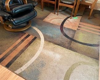 Several area rugs, geometric prints.
