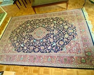 42- $275 Wool rug navy & pink florals 9’10” to the fringes x 6’1”                                 